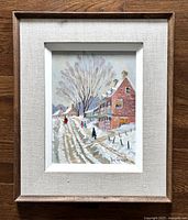Full view of framed oil painting showing winter scene on snow-covered street with houses and people walking.