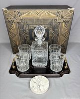 Full front view of complete set on tray with box in background showing one marble coaster in front