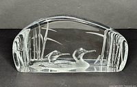 Front view of clear crystal sculpture showing two ducks and reeds engraving