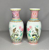 Front view of the pair of Chinese porcelain vases showing bird and floral design, 10 inches tall