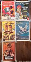 Five vintage reproduction movie posters displayed together, showing assorted titles with minor wear.