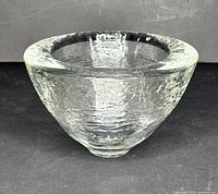 Front angled view showing textured clear art glass bowl shape and thickness of rim.