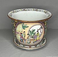 Front view of the vintage Chinese hand painted porcelain planter highlighting the colorful figure scene and floral border.