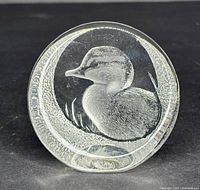 Front view of the crystal paperweight showing the carved duck and clear textured crystal surrounding it.