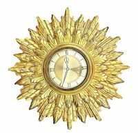 Full view of gold sunburst wall clock showcasing vintage MCM design, clock face with Roman numerals, and detailed gold plastic rays.