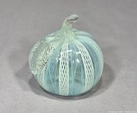 Front angled view showcasing white latticino stripes on light blue glass and clear leaf detail