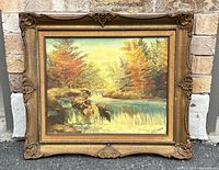 Full front view of the framed oil painting showing the landscape with waterfall and autumn trees in a decorative gold frame.