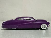 Side profile view of metallic purple 1949 Custom Mercury model car, showing classic custom car styling and smooth lines.