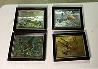 Photo showing all four framed color etch foil WWI airplane prints depicting various warplanes in aerial combat with black frames and gold inner trim edges.
