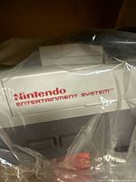 Front of NES console in plastic wrap showing logo