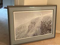 Full front view of framed print leaning against wall