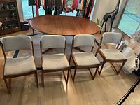 Four chairs arranged in front of a table showing overall set