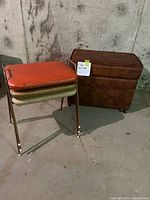 Photo of three vintage stacking stools and a brown hassock bench on wheels with storage in a basement setting.