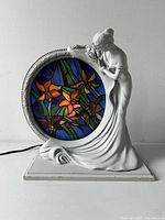 Front view showing lady sculpture and stained glass floral panel