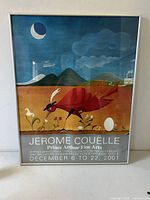 Full view of framed art poster featuring a stylized red bird in a landscape with moon and hills, signed by Jerome Couelle.