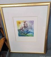 Frontal image of the framed fantasy etching showing the hand coloured artwork, gold-tone frame and white mat with artist signature.