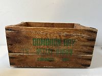 Side view of the wooden crate showing green printed Dominion Dry Toronto Division decals and natural wood finish.