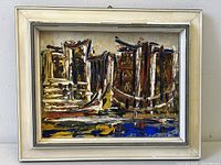 Frontal photo showing the framed oil painting with cityscape abstraction and signature.