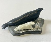 Front and side views of twin seal stone carving, showing details and condition including a tiny nick on the tail of the black seal.