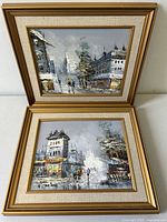 Pair of framed Paris street scene paintings with gold-tone frames and beige fabric mats, depicting impressionistic cityscapes with figures, trees, and buildings, signed K. Polany.