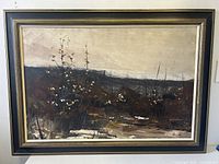 Front view of framed oil painting depicting shrubs and horizon under a muted sky