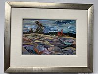 Frontal view of painting in silver frame with linen mat against white wall