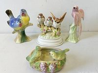 Front view of all four porcelain bird figurines including music box