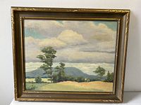 Front view of the framed oil painting depicting a stormy sky over a lush green landscape with trees and hills.