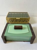 Two Art Deco boxes side by side, green glass and gold filigree style