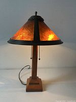 Lamp illuminated on, front view showing amber mica glow and metal trim