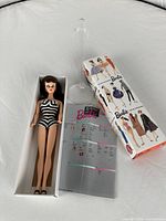 Doll, stand, and box laid out