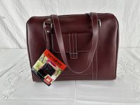 Front view of burgundy leather Samsonite laptop bag with tag attached