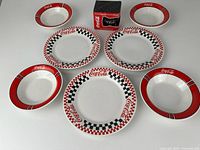 All pieces arranged: 3 plates, 4 bowls, boxed mug