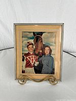 Full view of framed photograph standing on easel
