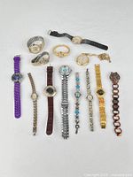 All 13 watches and bracelets laid out face up