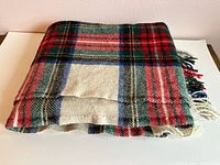 Folded multicolor wool tartan blanket showing pattern
