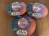Front view of three sealed Star Wars Micro Machines blister packs showing Millennium Falcon, X-Wing Fighter and Imperial Star Destroyer