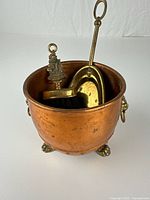 Copper pot with dustpan and brush inside
