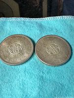 Two 1964 Canadian silver dollars showing the reverse side with Charlottetown Quebec floral emblem