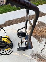 Side angled view of the metal trolley cart showing handle, wheels and platform.