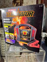 Box of Motomaster Eliminator Mobile Booster Pack showing branding, product image and specifications including 700 cranking amps and 1500 peak amps.