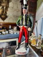 Front view of the vintage Irish Mist soldier ceramic figurine showing detailed clothing and base inscription.