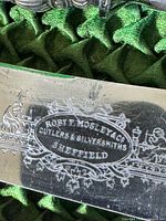 Close-up of maker's mark engraved 'Rob TF Mosley & Co Cutlers & Silversmiths Sheffield' on blade.