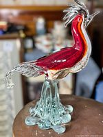 Side view of vintage Murano art glass rooster showing the vibrant red neck and textured white body with clear glass crowned comb and base.