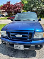 Front view of blue 2007 Ford Ranger showing grille, headlights, bumper and Ontario license plate