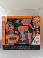 Front view of boxed Home Depot branded 10-piece deluxe toy power tool set showing all included items.