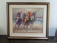 Full front view of the framed horseracing painting hanging or displayed against a wall with the entire frame visible.