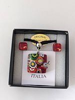Full view of Murano glass jewelry set including necklace and earrings in black gift box with Original Murano Glass label and card marked ITALIA.