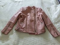 Front view of pink Zara leather-look jacket with asymmetric zipper and zippered pockets.