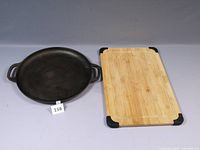 Photo of cast iron pan and wood cutting board showing overall condition and layout.